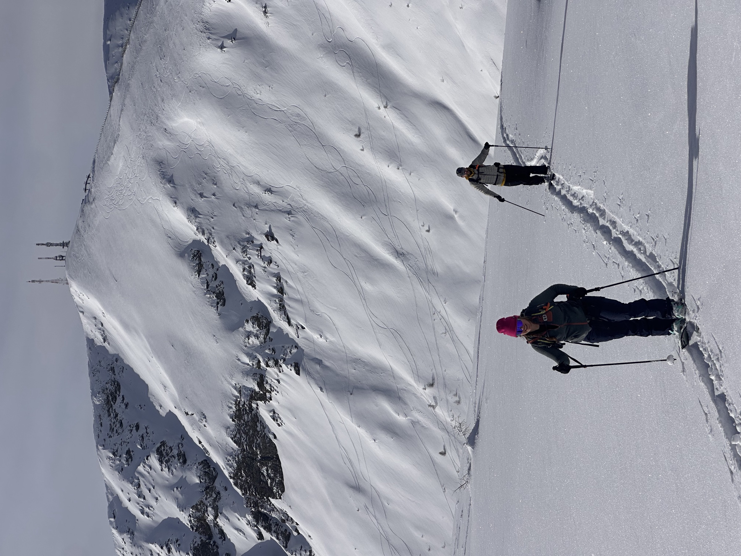 Students climbing on skins up a wide slope