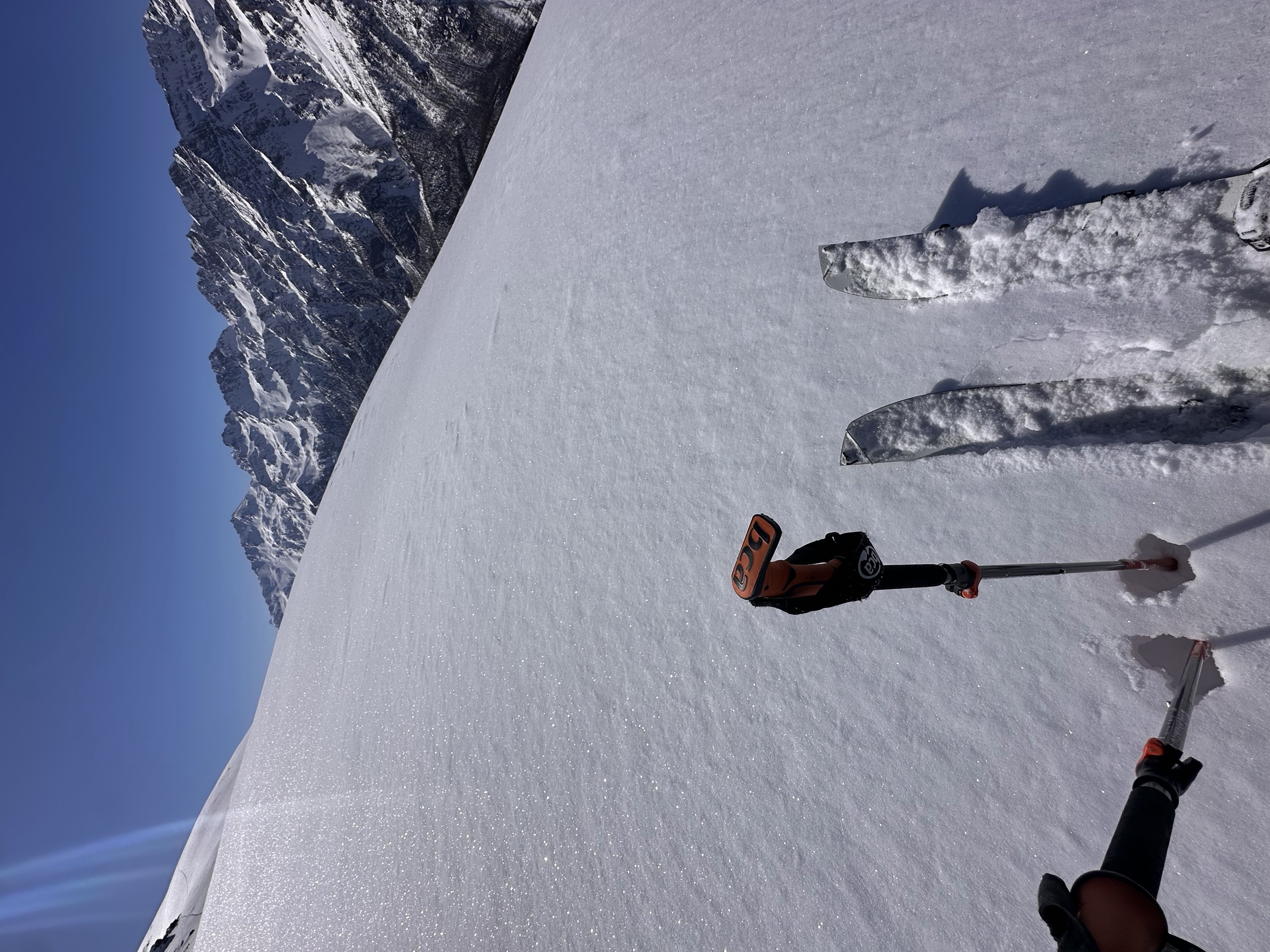 The splitboard split underfoot, climbing towards the ridge